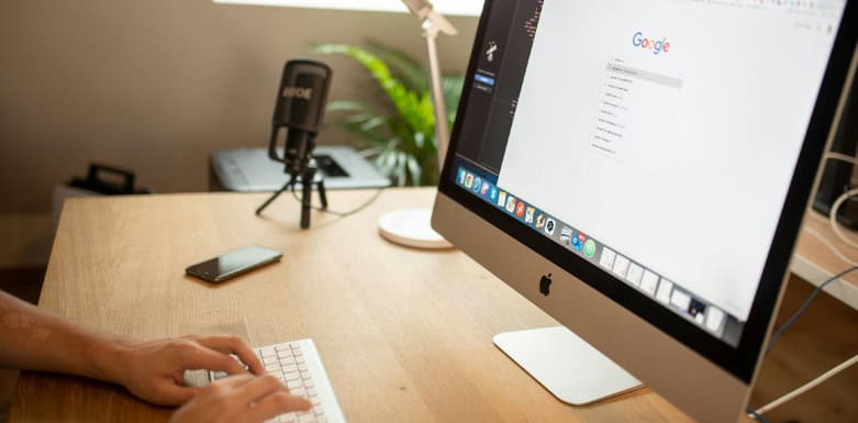 Intenção de busca: saiba como influencia no SEO Pessoa digitando na busca do Google pelo computador.