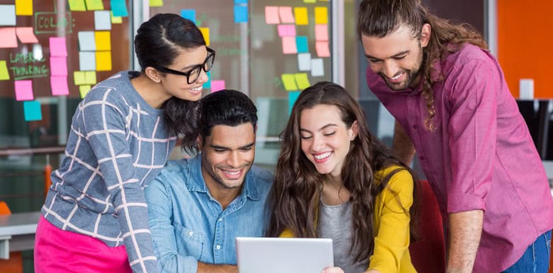 Agência de SEO: como fazer a escolha correta? Equipe de agência reunida ao redor de um notebook.