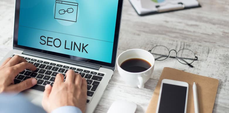Comprar backlink vale a pena? Entenda os riscos e benefícios Imagem de pessoa digitando